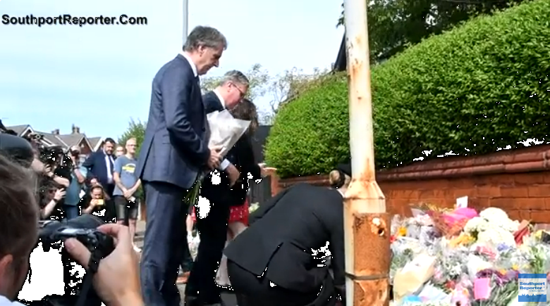 The laying down of floral tribute at the scene of the knife attack in Southport